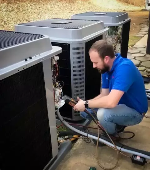 Technician working on a customer's HVAC unit